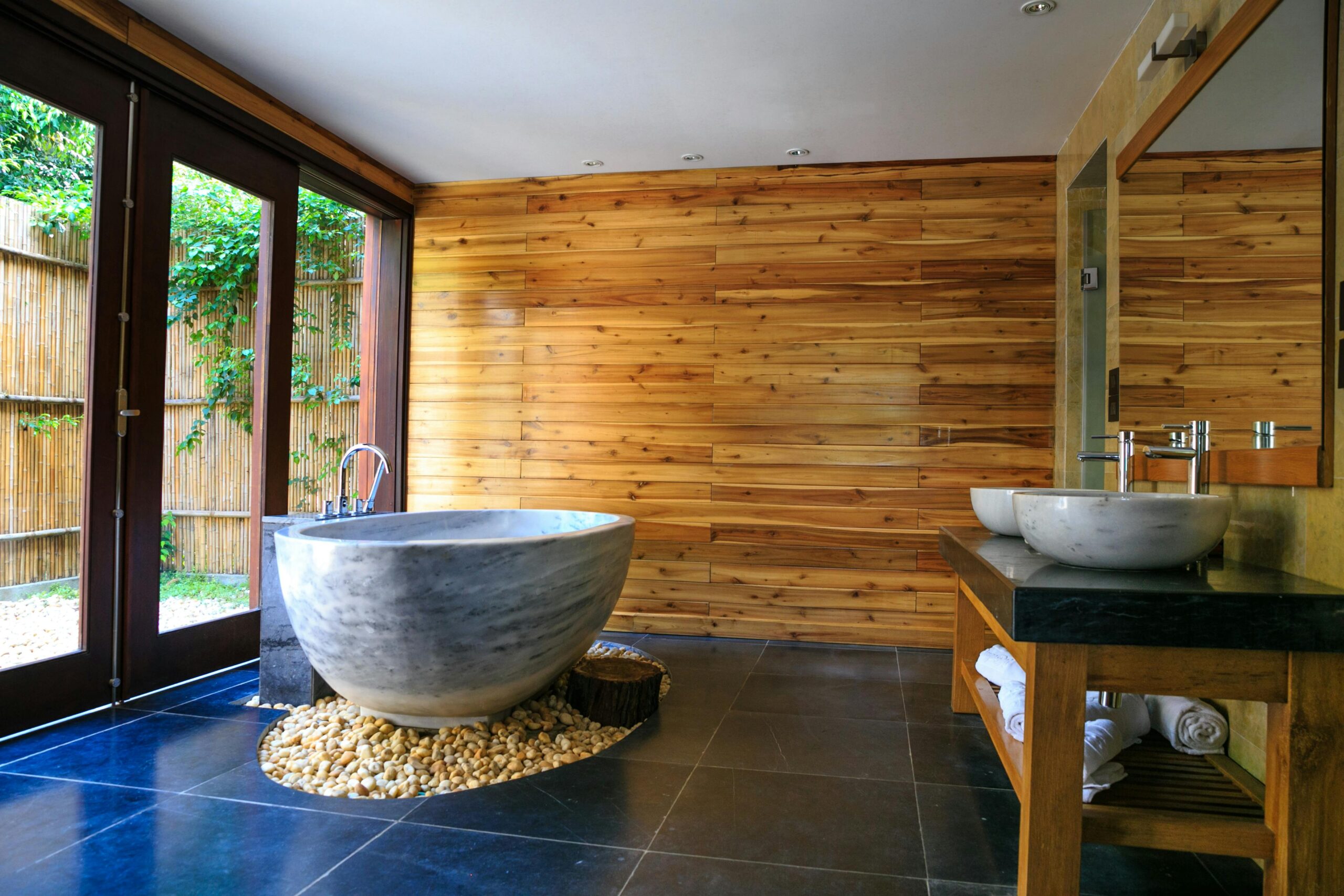 Services Elegant bathroom showcasing a modern marble tub and wooden interior for a serene escape.